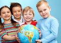 Group of adorable boys and girl with globe