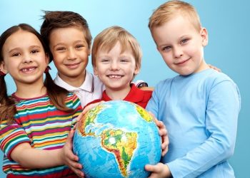 Group of adorable boys and girl with globe