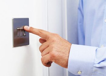 Close Up Of Man Turning Off Light Switch